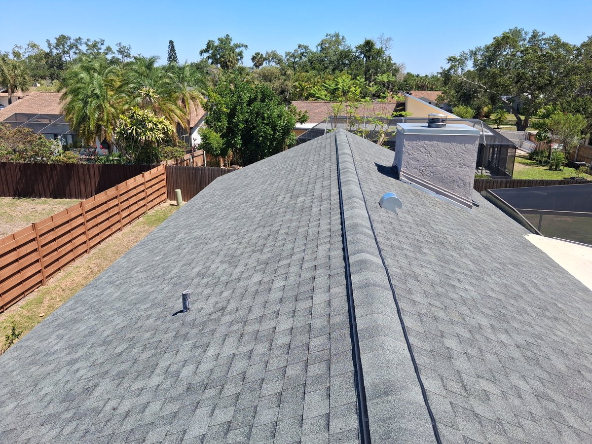 Completed architectural shingle roof with backyard view in Sarasota, FL
