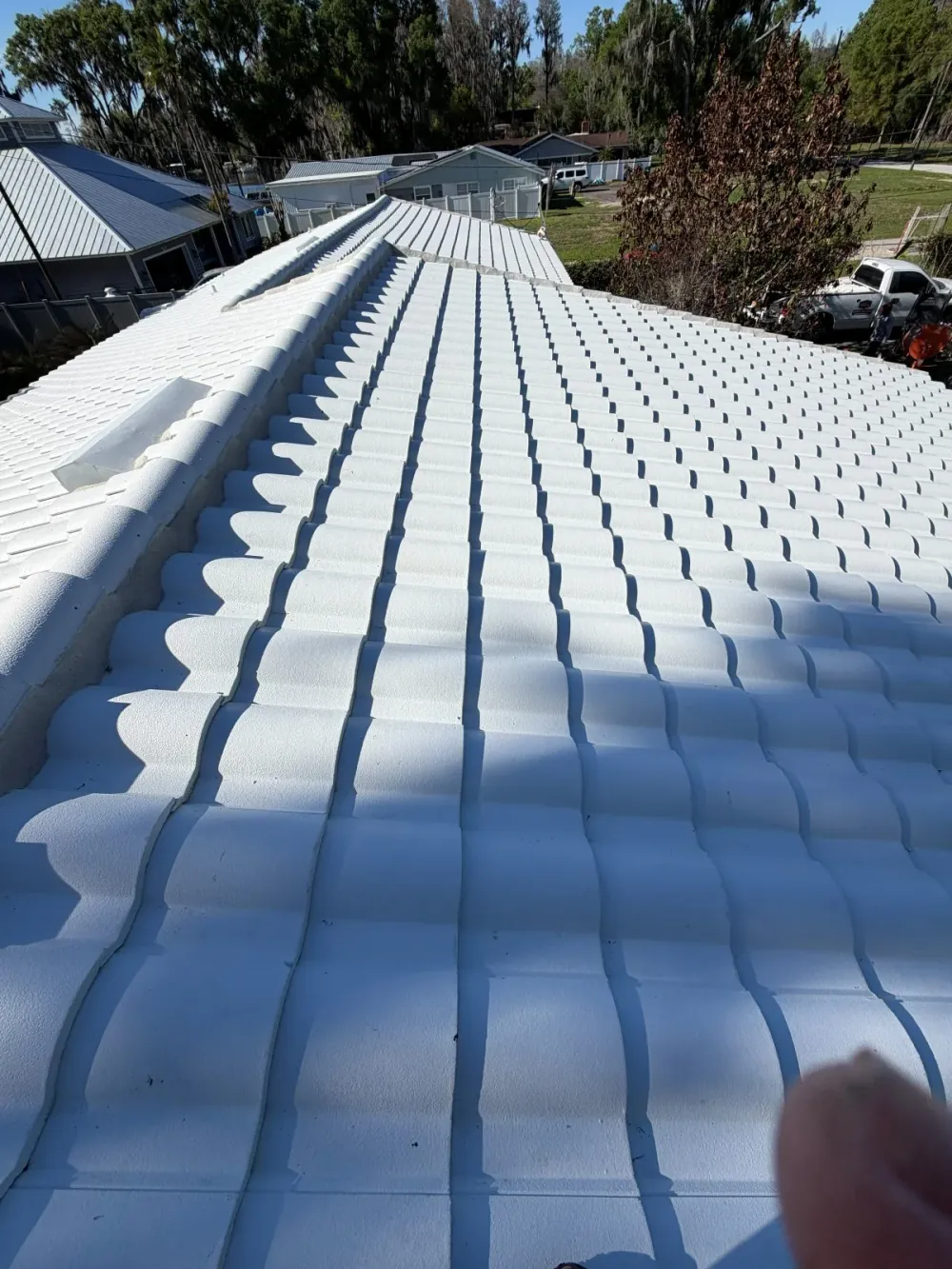 S-tile roof restoration on a Sarasota home — white concrete tile after coating