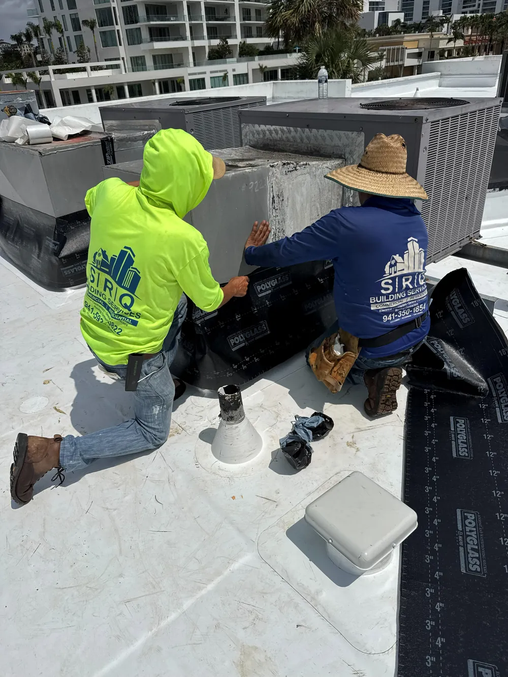 SRQ Building Services crew repairing a commercial roof in Sarasota, FL