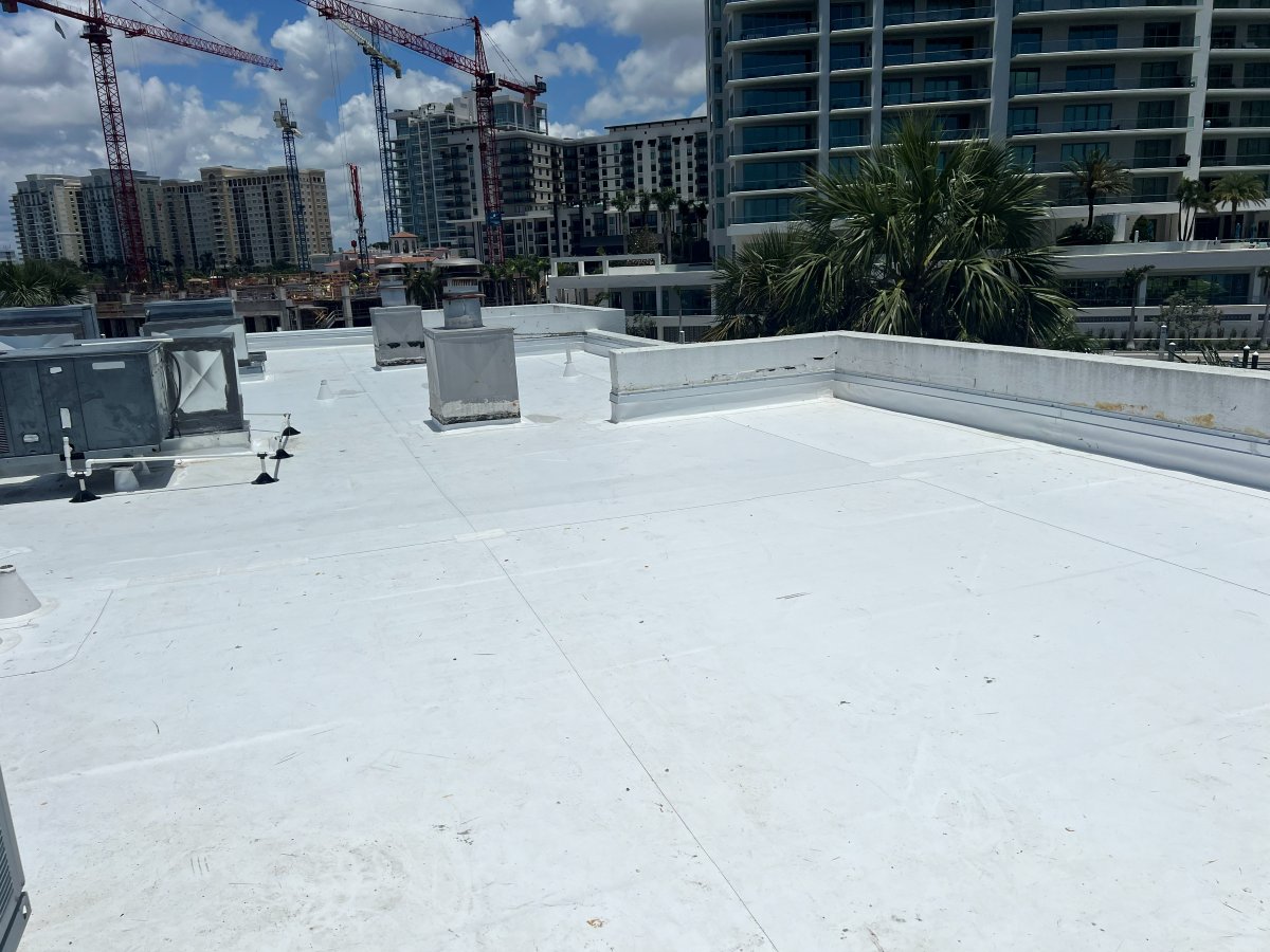 Completed white flat roof membrane with downtown Sarasota skyline in background