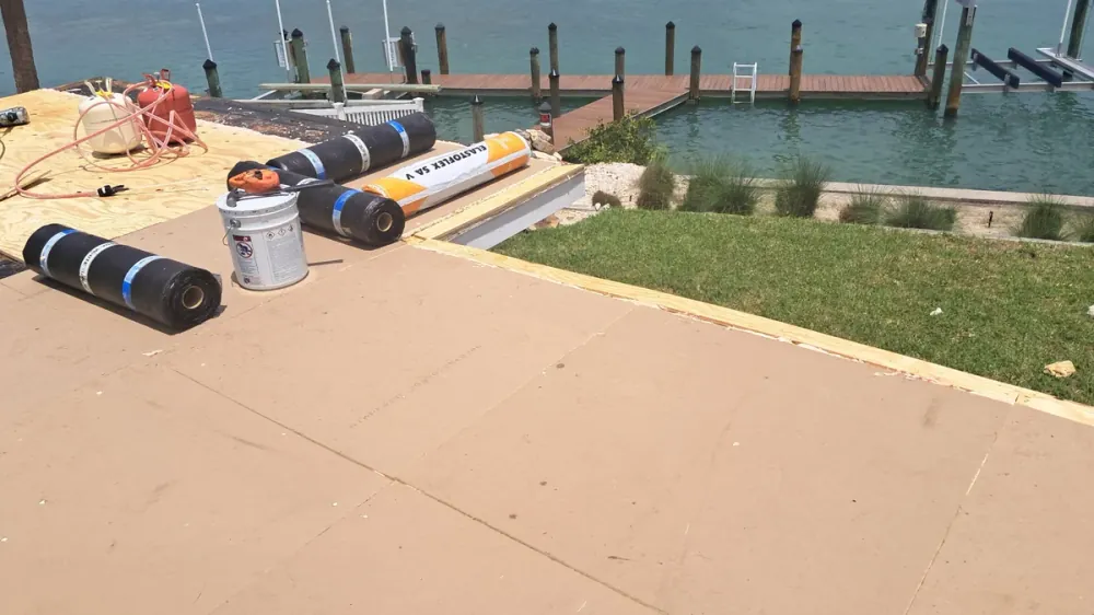 Modified bitumen rolls staged for installation at a waterfront flat roof in Sarasota