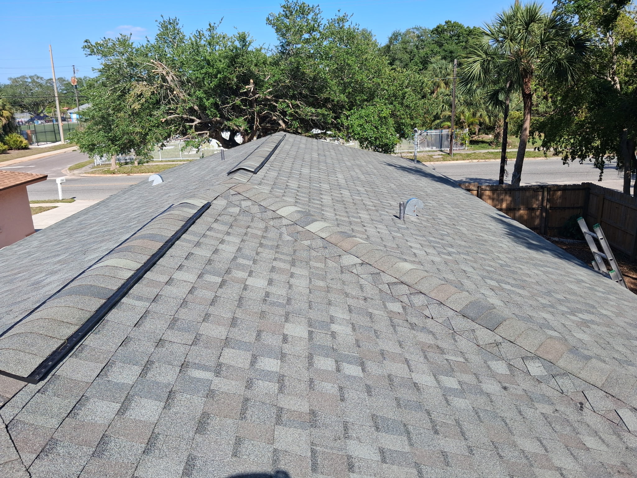 SRQ Building Services crew performing routine roof maintenance in Sarasota
