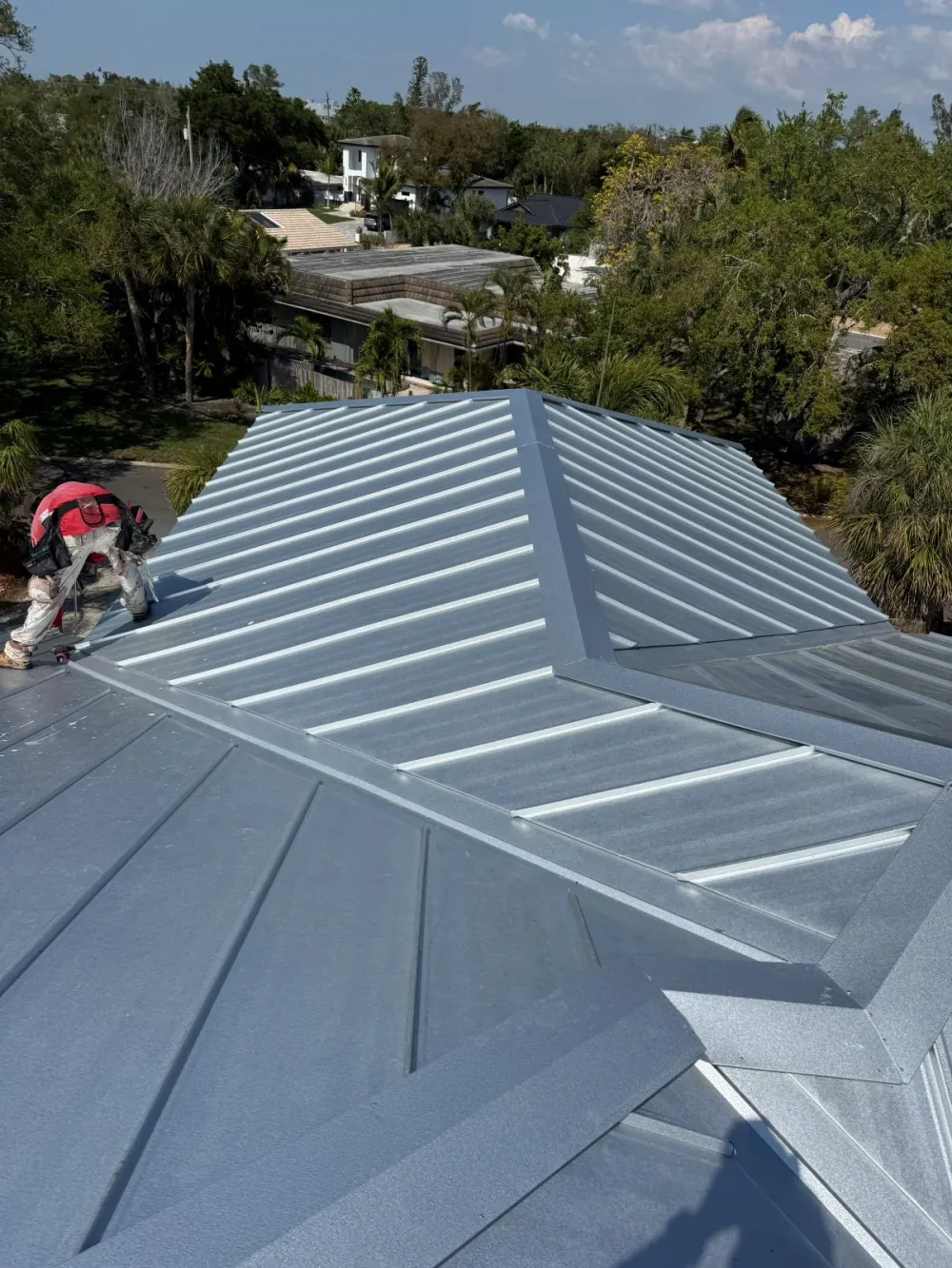 Standing seam steel roof installation showing concealed fasteners on a Sarasota home