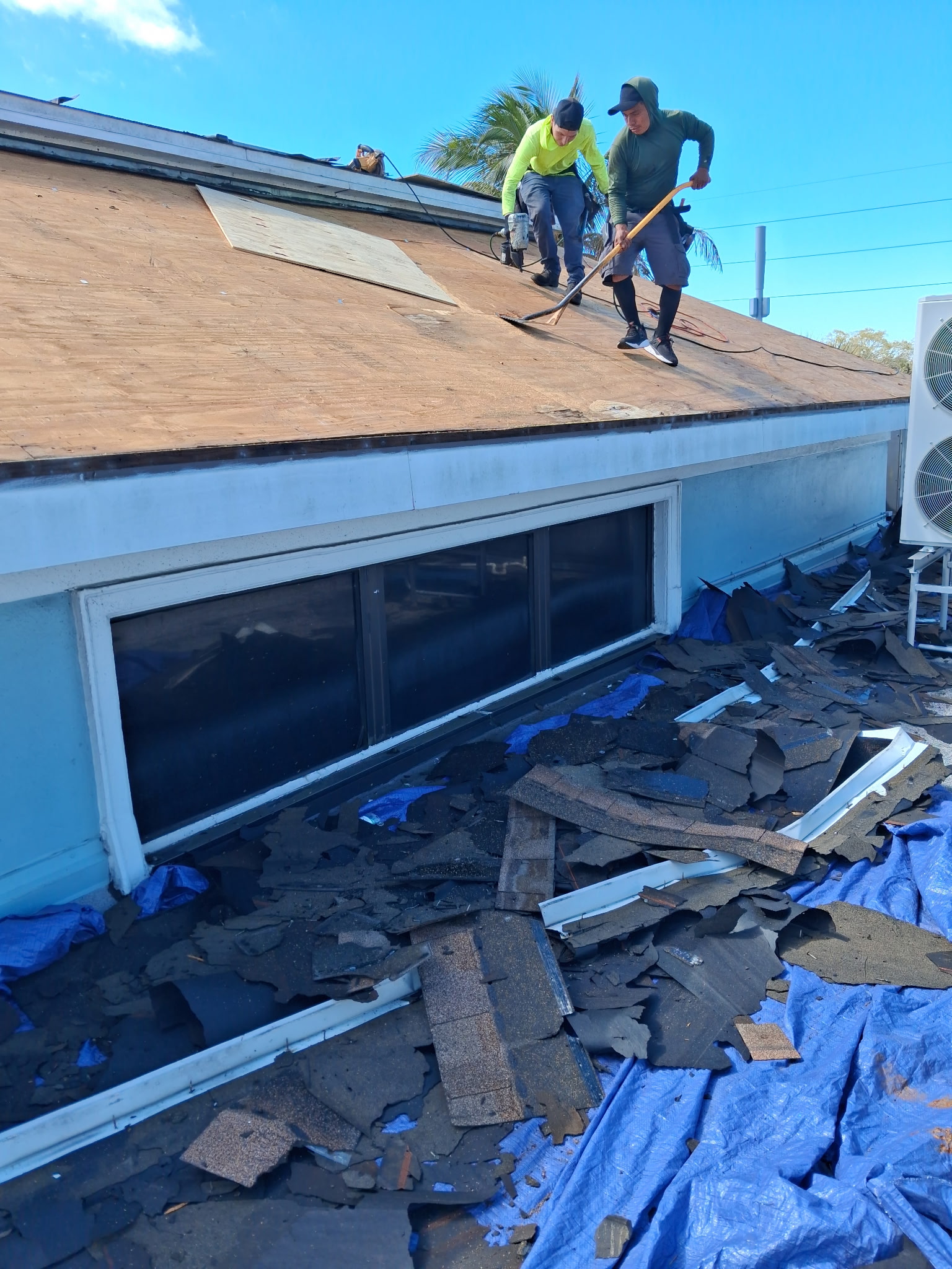 SRQ Building Services assessing storm damage vs normal wear on a Sarasota roof