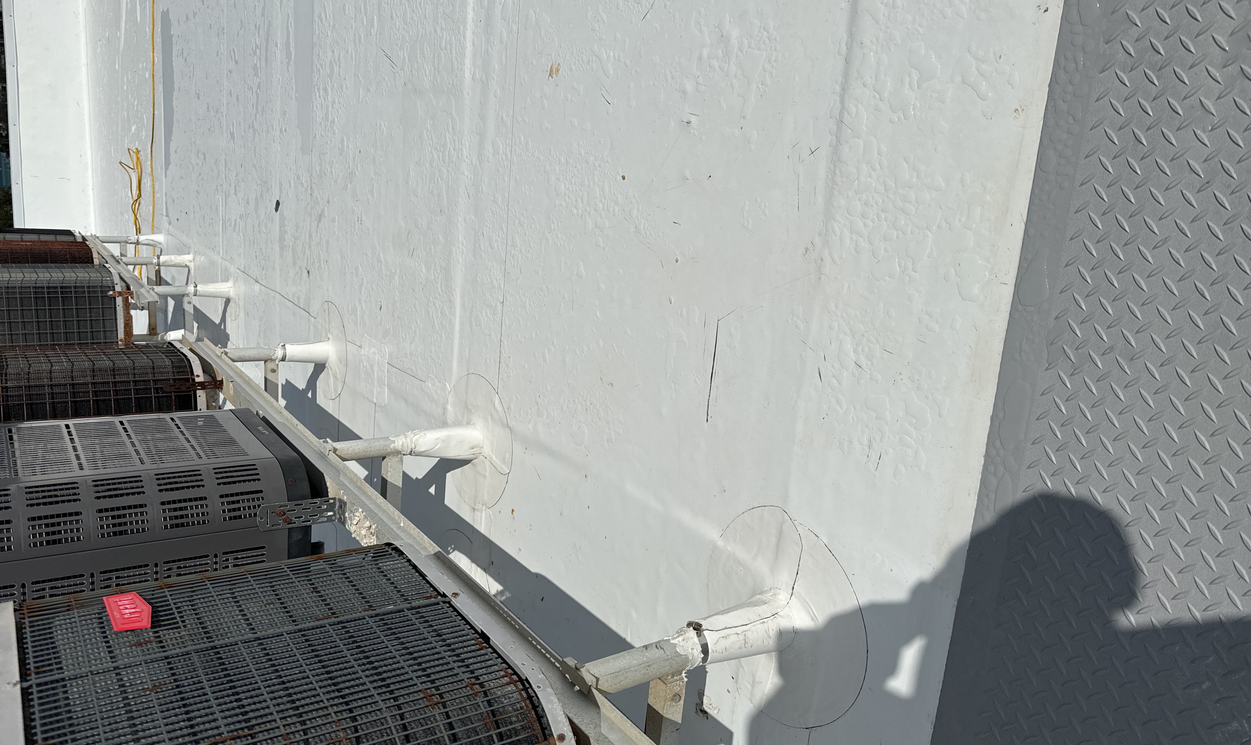 Sealed pipe boot penetrations on a white TPO commercial roof in Sarasota