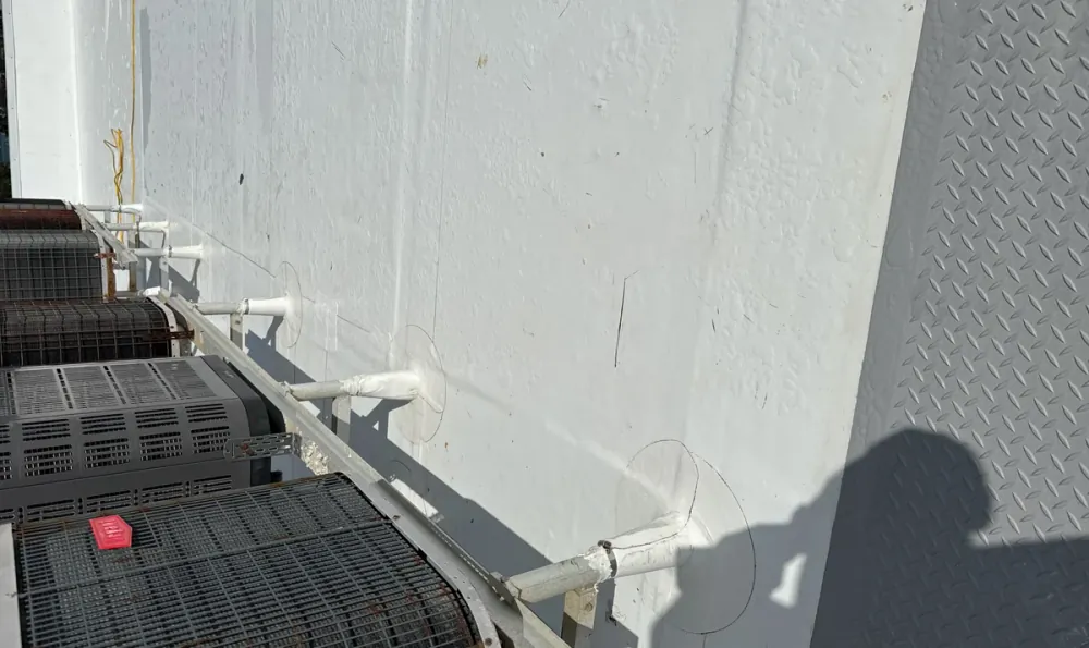 Sealed pipe boot penetrations on a white TPO commercial roof in Sarasota